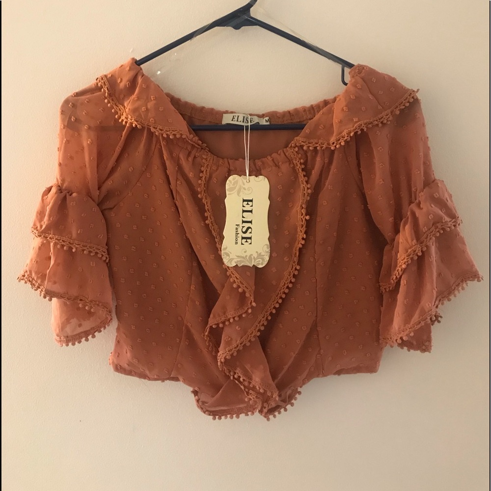 Deep orange, fluffy blouse.